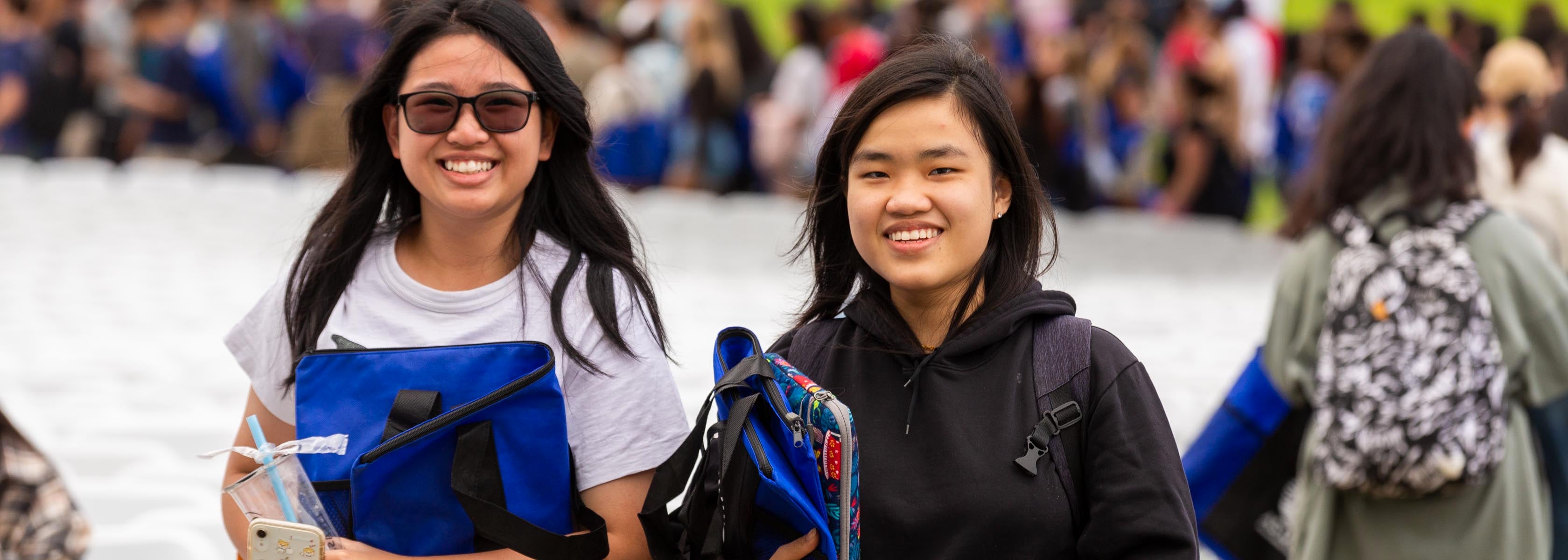 Students smile at the camera at Convocation