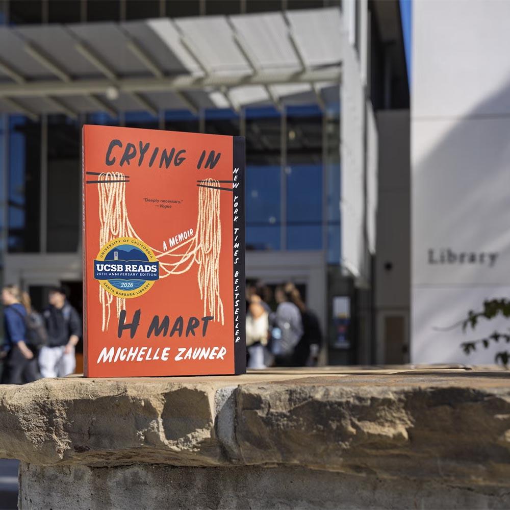 Michelle Zauner's book "Crying in H Mart" on a rock outside UCSB Library
